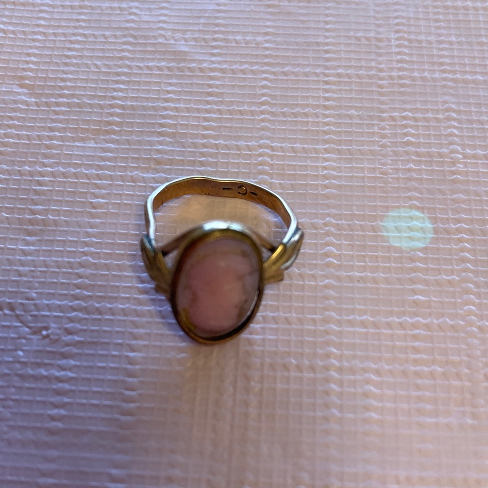 Tiny gold ring with a delicate face similar to a cameo